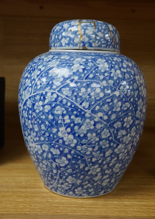 A Japanese Seto blue and white lidded ginger jar, 24cm high. Condition - lid poor (repaired in Kitsugi fashion with staples and filler visible to interior) body fair with one visible star crack.